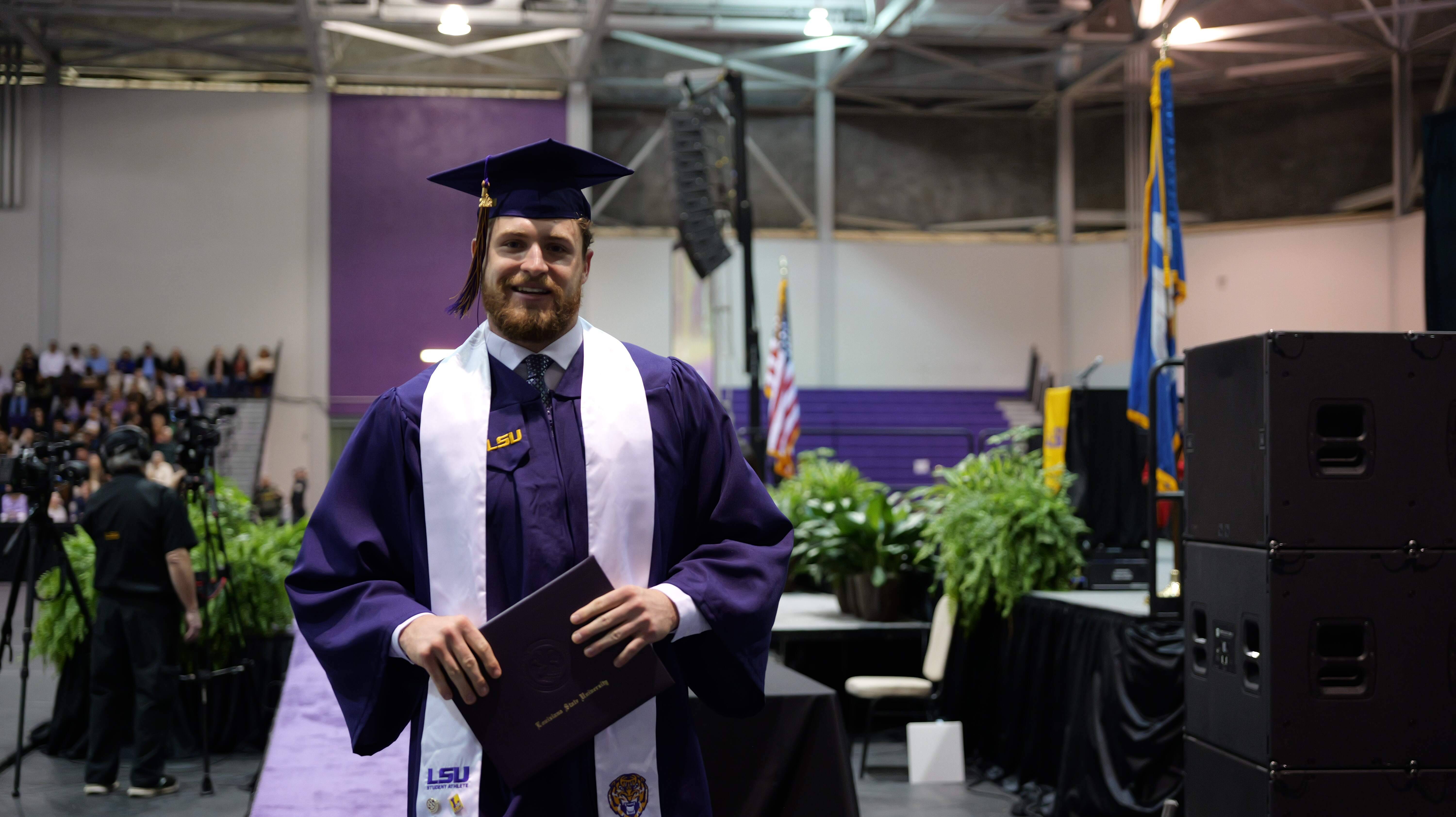 Graduate holding diploma