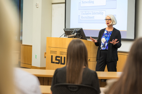 Lydia Lafleur stands at the front of the classroom and talks about the program's benefits. 