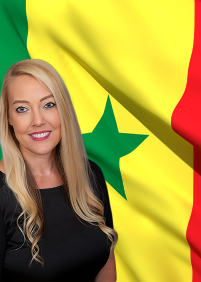 Ashley Clayton in front of a flag from Senegal