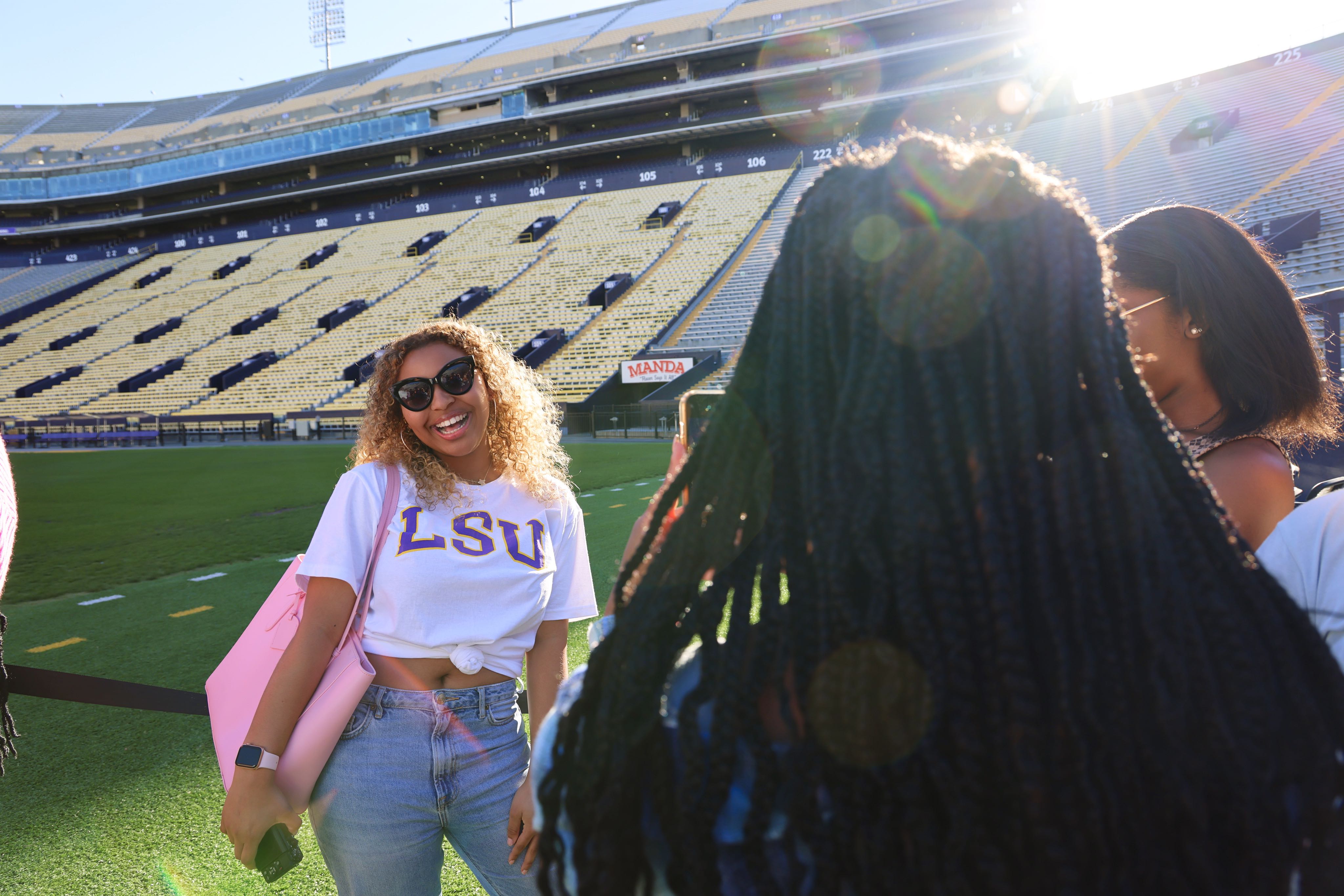 Mass Communication students taking photos in Tiger Stadium.