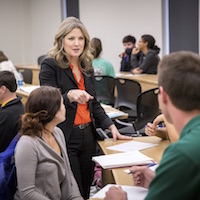 Students listen to presentation in human resource education class.