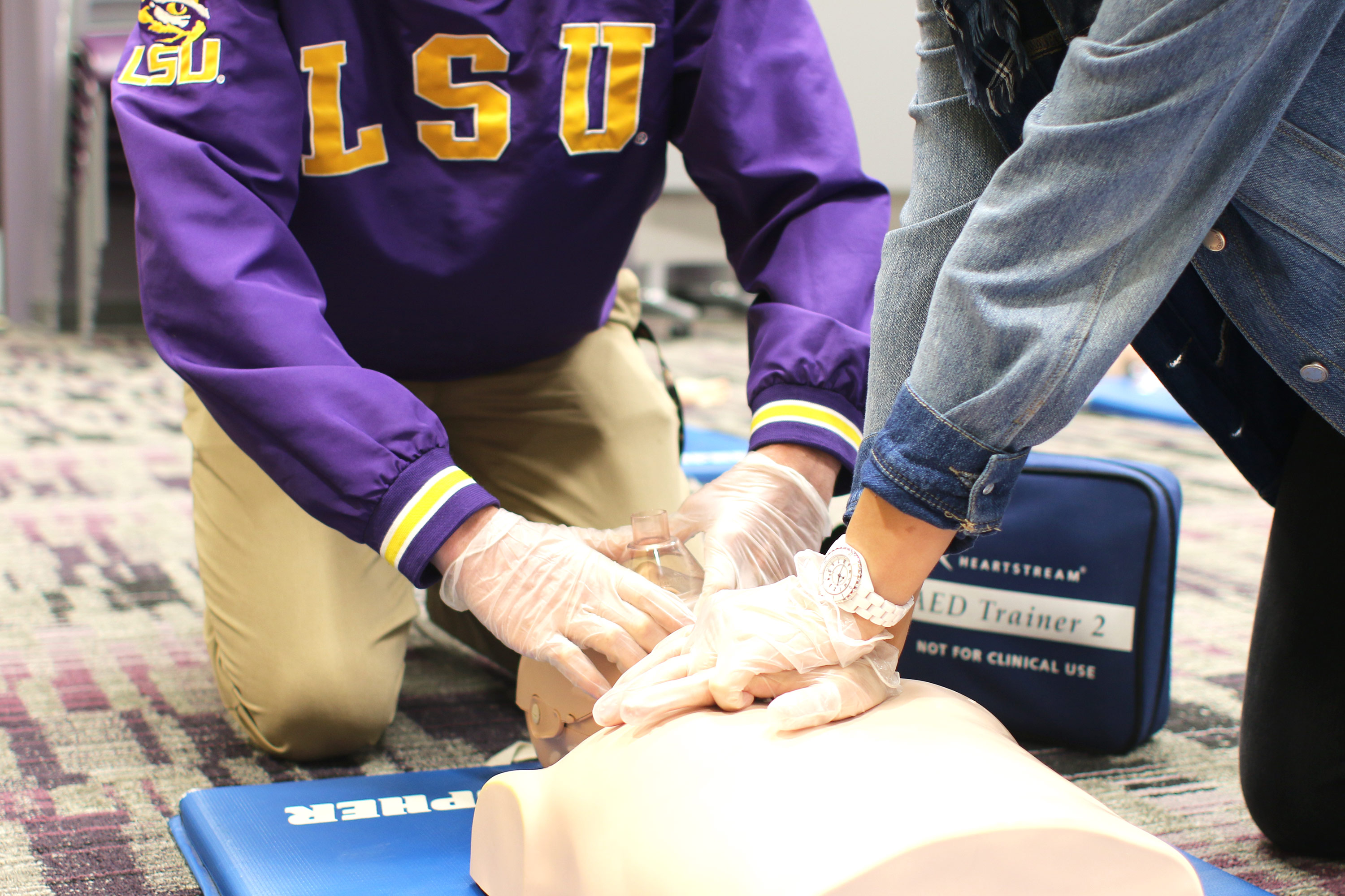 close up of hands doing cpr on a maniquine